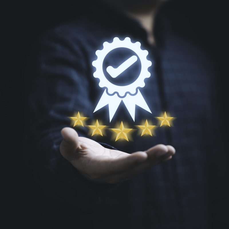 Businessman holding and showing the best quality assurance with Businessman holding and showing the best quality assurance with golden five stars for guarantee product and ISO service concept.