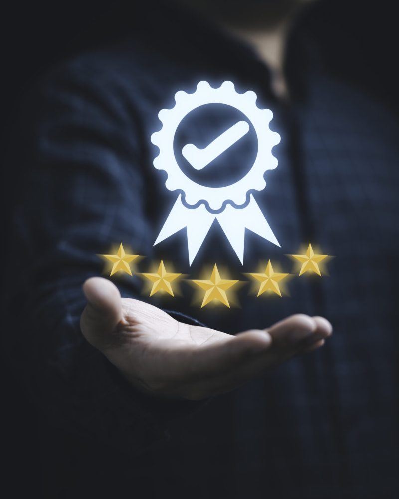 Businessman holding and showing the best quality assurance with Businessman holding and showing the best quality assurance with golden five stars for guarantee product and ISO service concept.